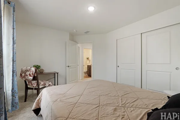 a bedroom with a bed and chair