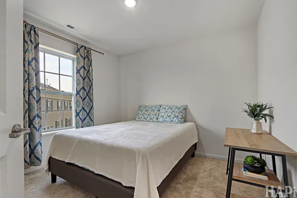 a bedroom with a bed and a table
