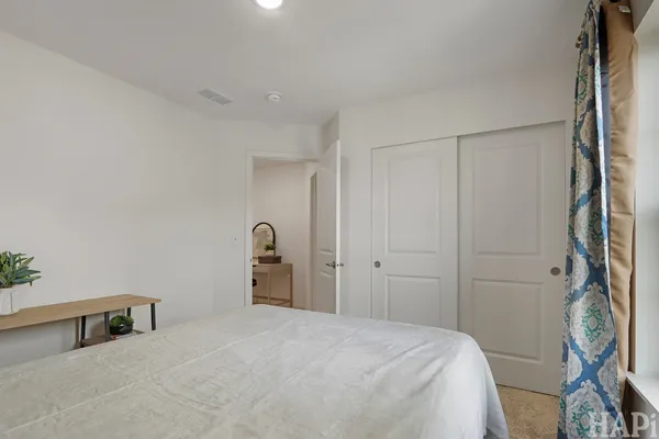 a bedroom with a bed and a cabinet