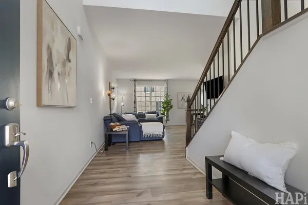 a living room with furniture and a wooden floor