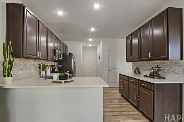 a kitchen with sink cabinets and stainless steel appliances