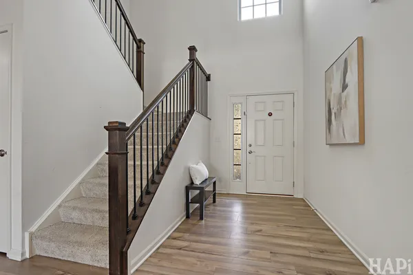 a view of a hallway with wooden floor and staircase
