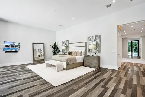 a spacious bedroom with a large bed and a large window