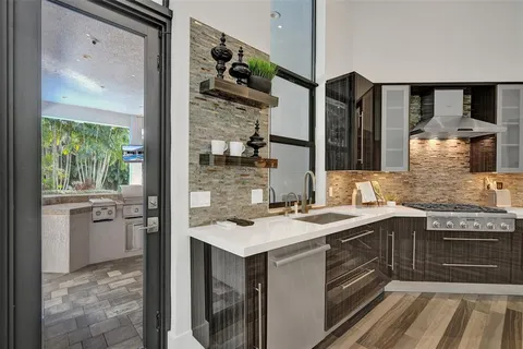 a view of a patio with a dining table and chairs with a potted plants
