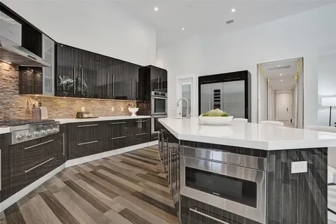 a living room with patio furniture and a floor to ceiling window