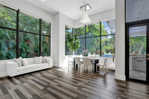 a living room with patio furniture and a large window