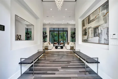a lobby with furniture and a chandelier
