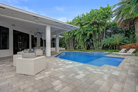 an aerial view of a house with a yard and outdoor seating