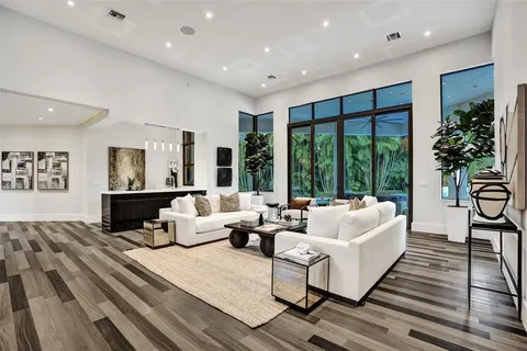 a living room with furniture and large windows