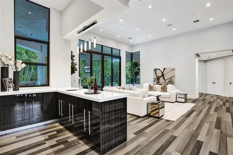 a very nice looking living room with a large window and wooden floor