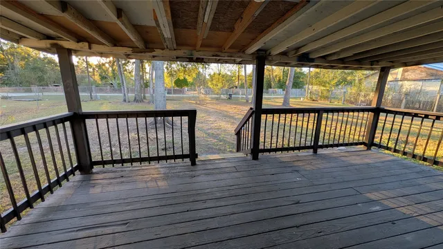 a view of porch with wooden floor