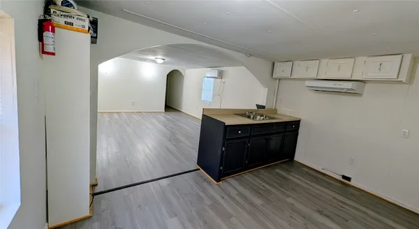 a kitchen with stainless steel appliances granite countertop a sink and a refrigerator