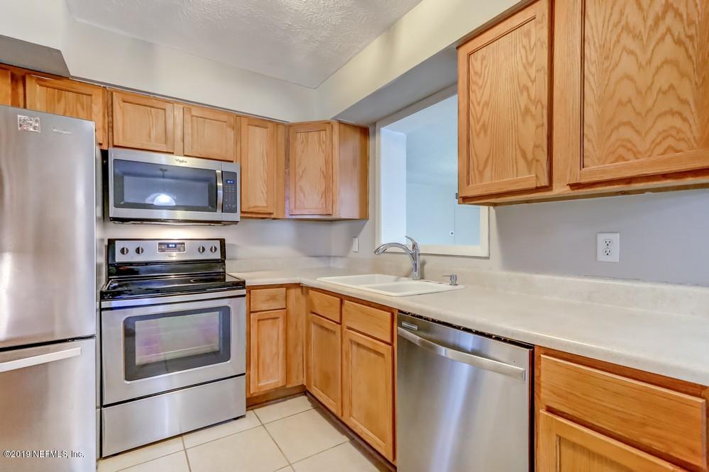 4427 Barnes Road South Jacksonville, FL 32207 - Photo 11 of 39 a kitchen with stainless steel appliances granite countertop a sink stove and microwave