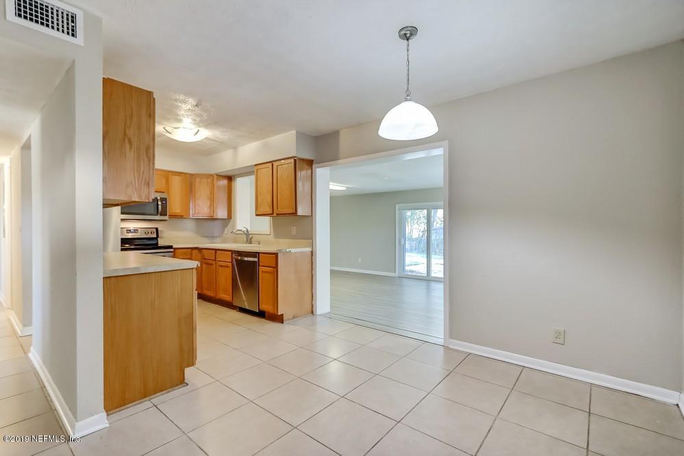 4427 Barnes Road South Jacksonville, FL 32207 - Photo 14 of 39 a kitchen with stainless steel appliances granite countertop a stove a sink and a refrigerator