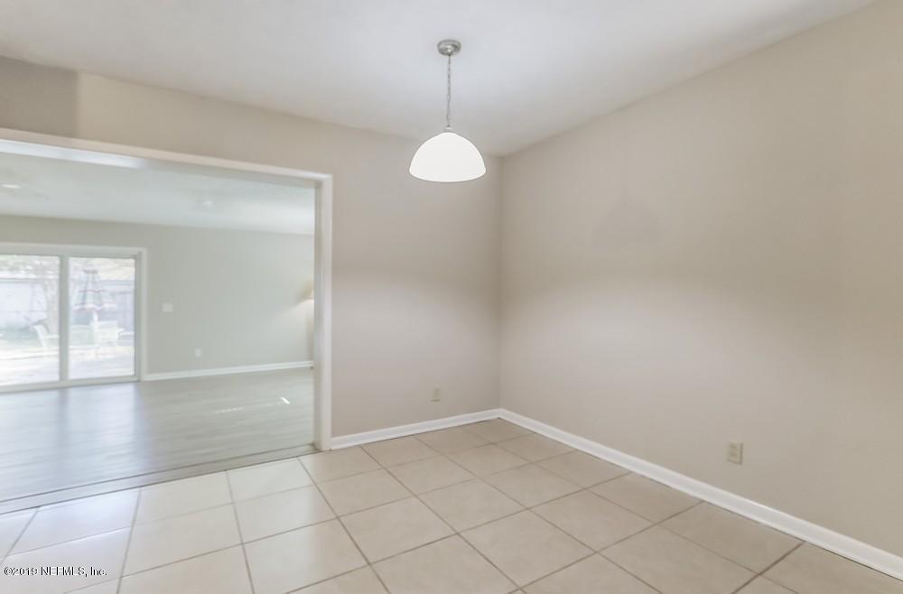 4427 Barnes Road South Jacksonville, FL 32207 - Photo 16 of 39 an empty room with wooden floor and windows
