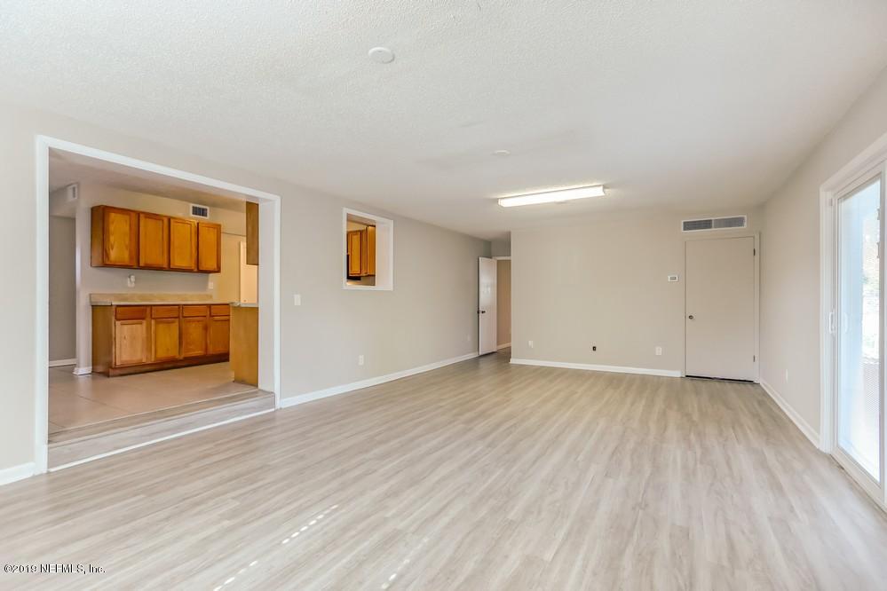 4427 Barnes Road South Jacksonville, FL 32207 - Photo 17 of 39 an empty room with a fireplace and a window