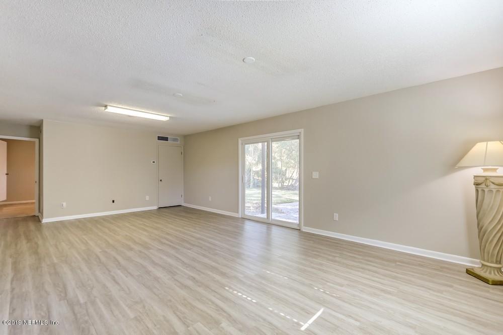 4427 Barnes Road South Jacksonville, FL 32207 - Photo 18 of 39 a view of an empty room with wooden floor and a window