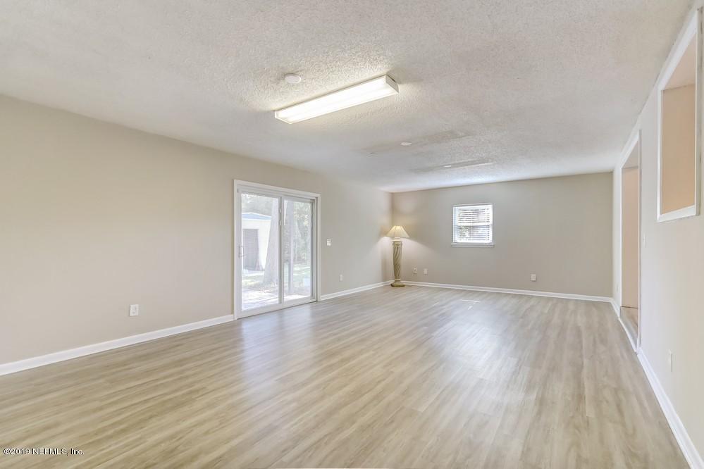 4427 Barnes Road South Jacksonville, FL 32207 - Photo 19 of 39 a view of an empty room with wooden floor and window