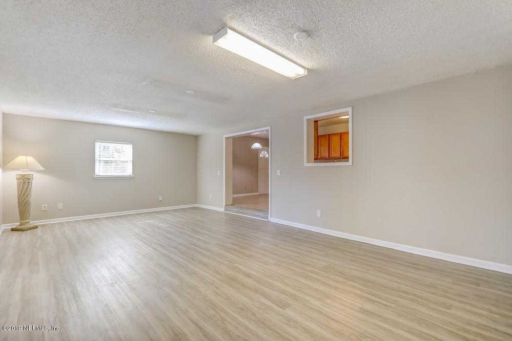 4427 Barnes Road South Jacksonville, FL 32207 - Photo 20 of 39 a view of an empty room with wooden floor and a window