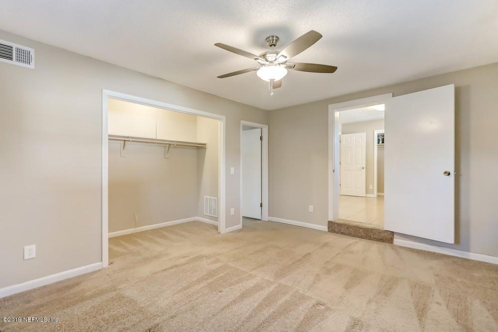 4427 Barnes Road South Jacksonville, FL 32207 - Photo 21 of 39 a view of an empty room with a ceiling fan