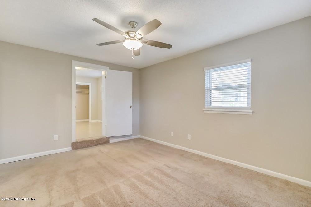 4427 Barnes Road South Jacksonville, FL 32207 - Photo 23 of 39 an empty room with windows and fan