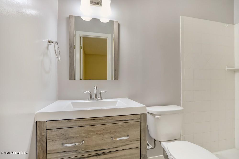 4427 Barnes Road South Jacksonville, FL 32207 - Photo 27 of 39 a bathroom with a toilet sink and mirror