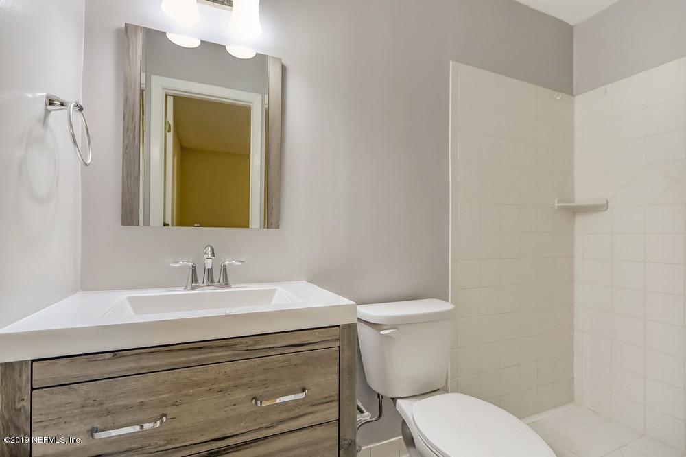 4427 Barnes Road South Jacksonville, FL 32207 - Photo 28 of 39 a bathroom with a toilet sink and mirror