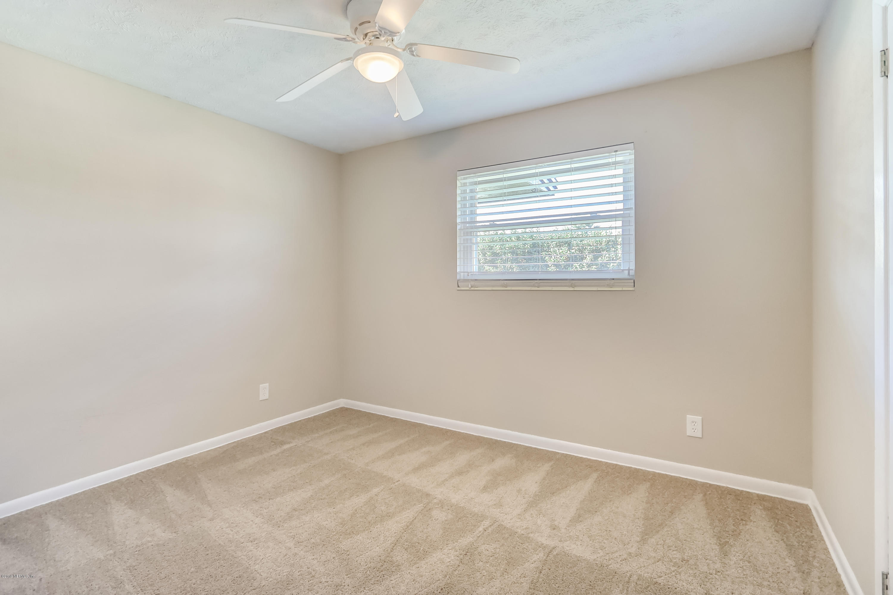 4427 Barnes Road South Jacksonville, FL 32207 - Photo 29 of 39 an empty room with a window