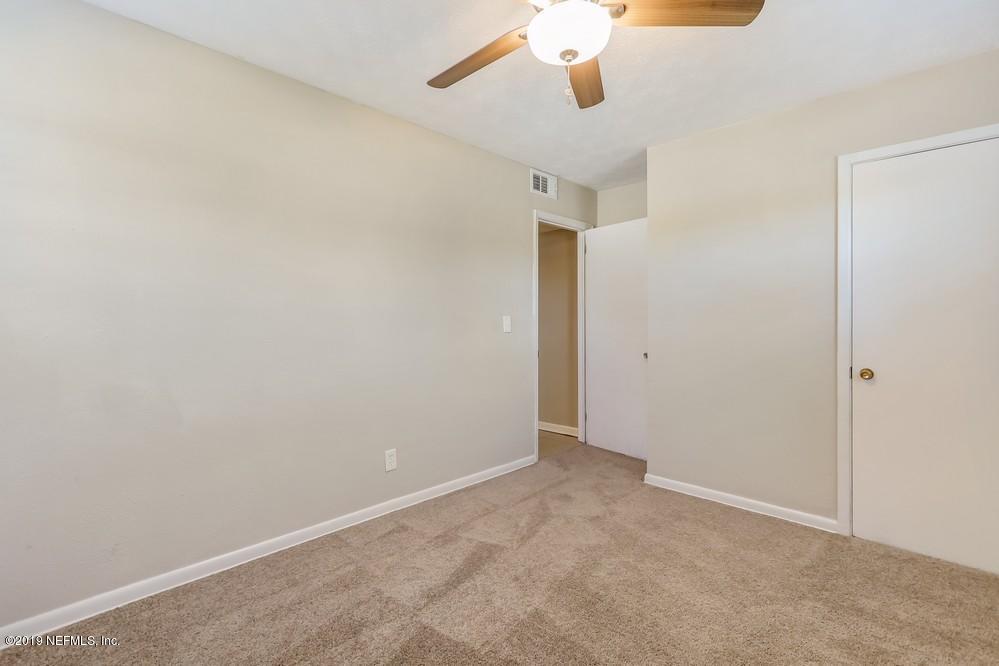 4427 Barnes Road South Jacksonville, FL 32207 - Photo 32 of 39 an empty room with a chandelier fan