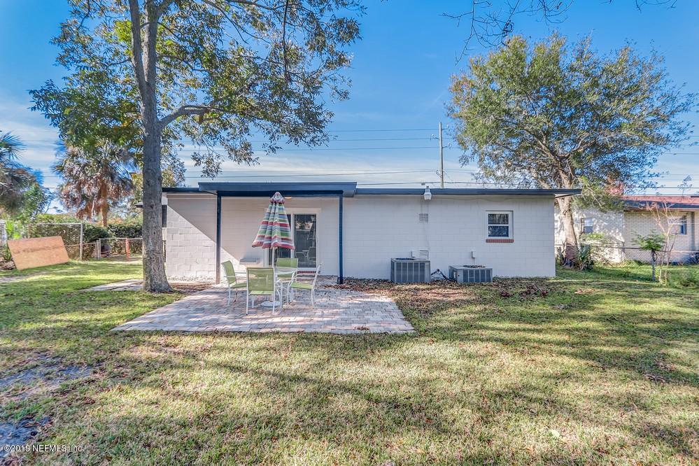 4427 Barnes Road South Jacksonville, FL 32207 - Photo 36 of 39 a backyard of a house with table and chairs plants and large tree