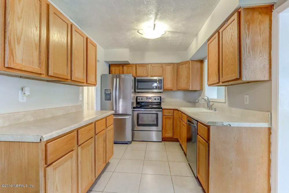 4427 Barnes Road South Jacksonville, FL 32207 - Photo 10 of 39 a kitchen with stainless steel appliances granite countertop a refrigerator and a stove top oven