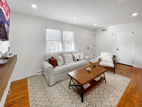 a living room with furniture and a rug