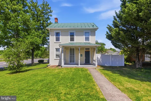 a front view of a house with a yard and porch