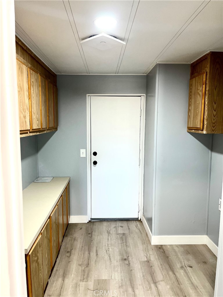 16336 Yuma Road Apple Valley, CA 92307 - Photo 11 of 18 a view of hallway with window and wooden floor