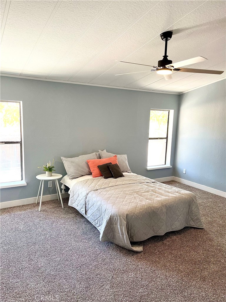 16336 Yuma Road Apple Valley, CA 92307 - Photo 12 of 18 a bedroom with a bed and a window