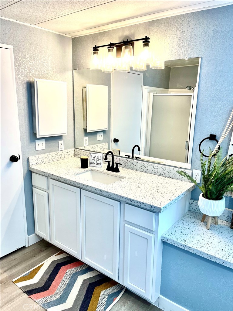 16336 Yuma Road Apple Valley, CA 92307 - Photo 14 of 18 a bathroom with a granite countertop sink and a mirror
