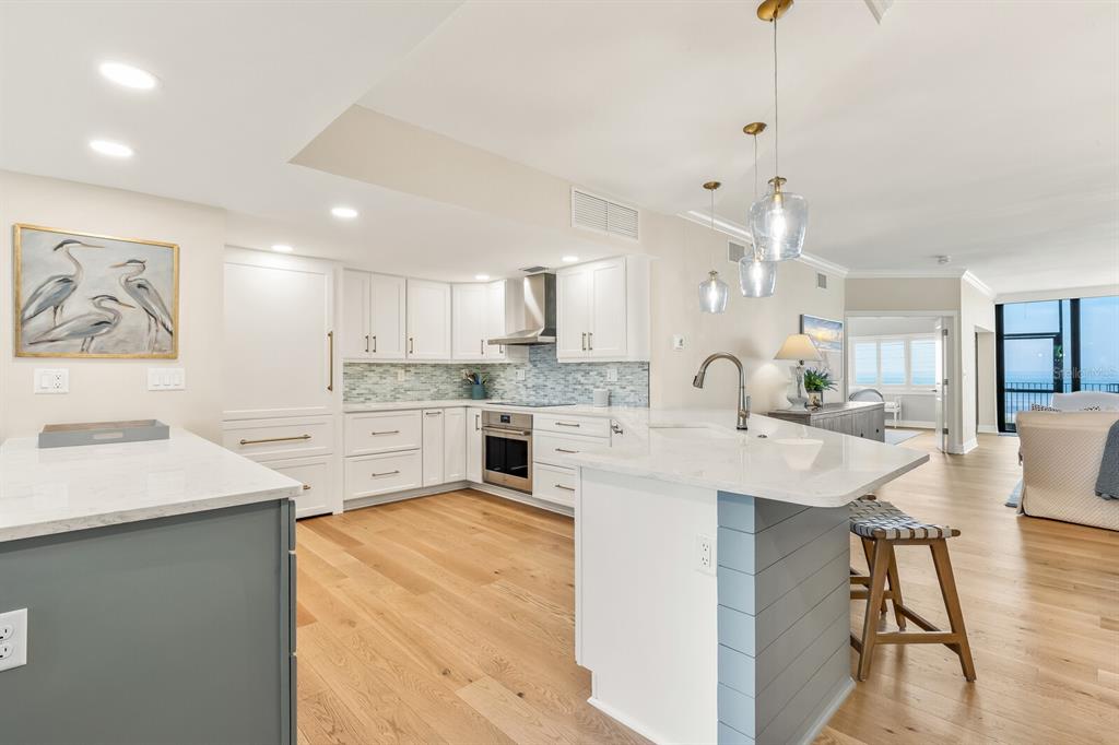 5000 Gasparilla Road, Unit 29A Boca Grande, FL 33921 - Photo 11 of 40 a large white kitchen with lots of counter space sink and refrigerator