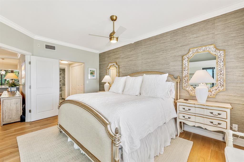 5000 Gasparilla Road, Unit 29A Boca Grande, FL 33921 - Photo 15 of 40 a bedroom with a bed and wooden floor