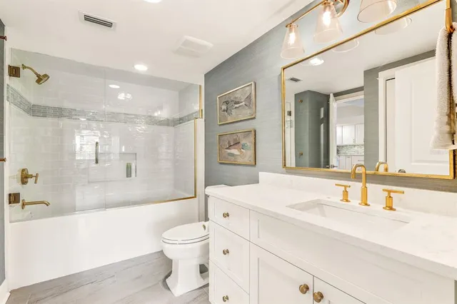 a dining hall with stainless steel appliances kitchen island granite countertop a table chairs and a large window