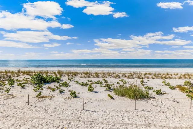 a living room with patio furniture and a large window