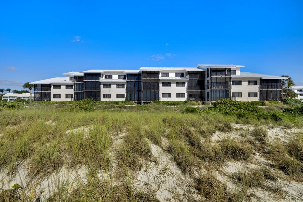 5000 Gasparilla Road, Unit 29A Boca Grande, FL 33921 - Photo 3 of 40 a view of a large building with a yard