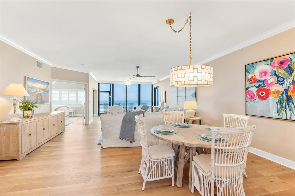 5000 Gasparilla Road, Unit 29A Boca Grande, FL 33921 - Photo 5 of 40 a view of a dining room with furniture wooden floor and a chandelier