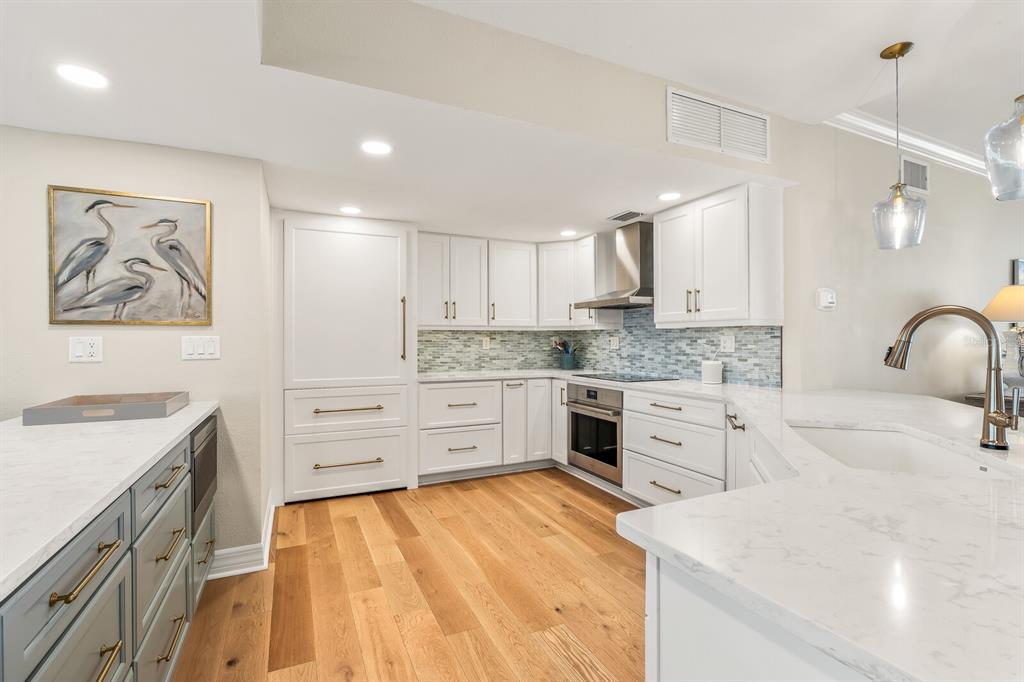 5000 Gasparilla Road, Unit 29A Boca Grande, FL 33921 - Photo 9 of 40 a kitchen with a stove a sink and a refrigerator