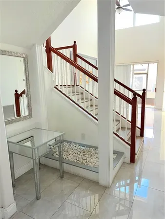 a bathroom with a granite countertop sink a toilet and a mirror