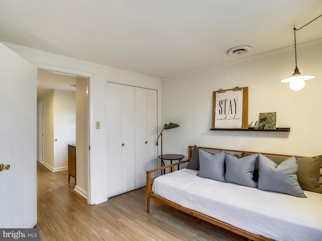 a bedroom with a large bed and a chandelier