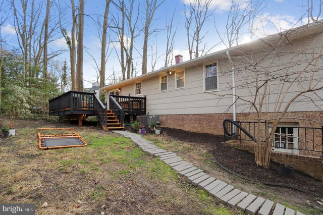 a view of a house with a yard and wooden fence