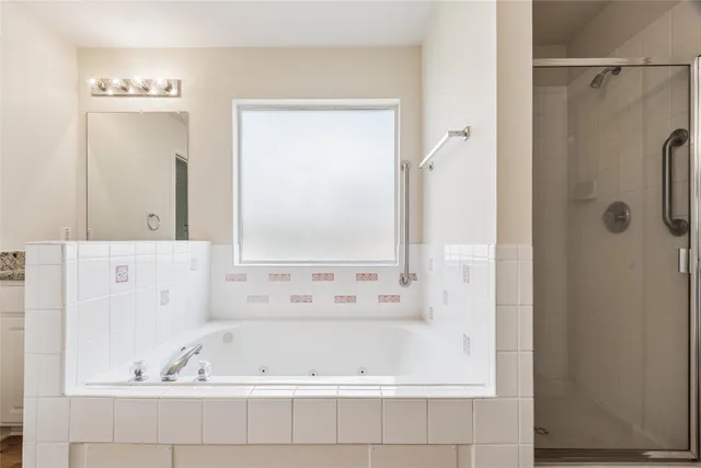 a bathroom with a bathtub and a shower