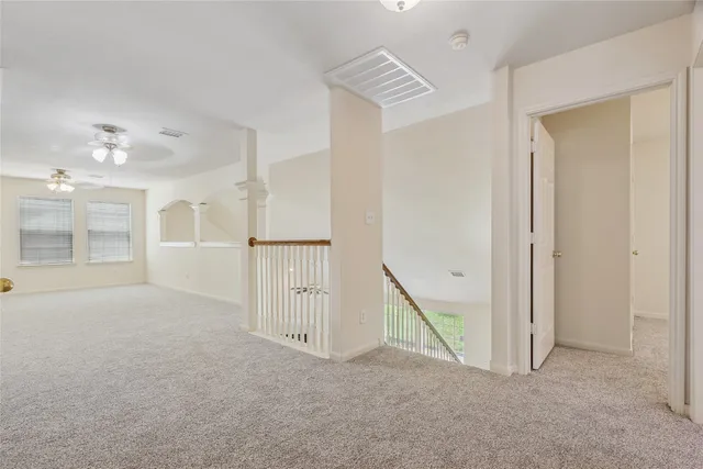 an empty room with windows and pillars in it