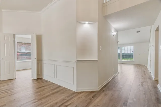 a view of a hallway with wooden floor