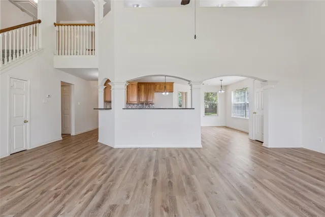 a view of a room with wooden floors and white walls